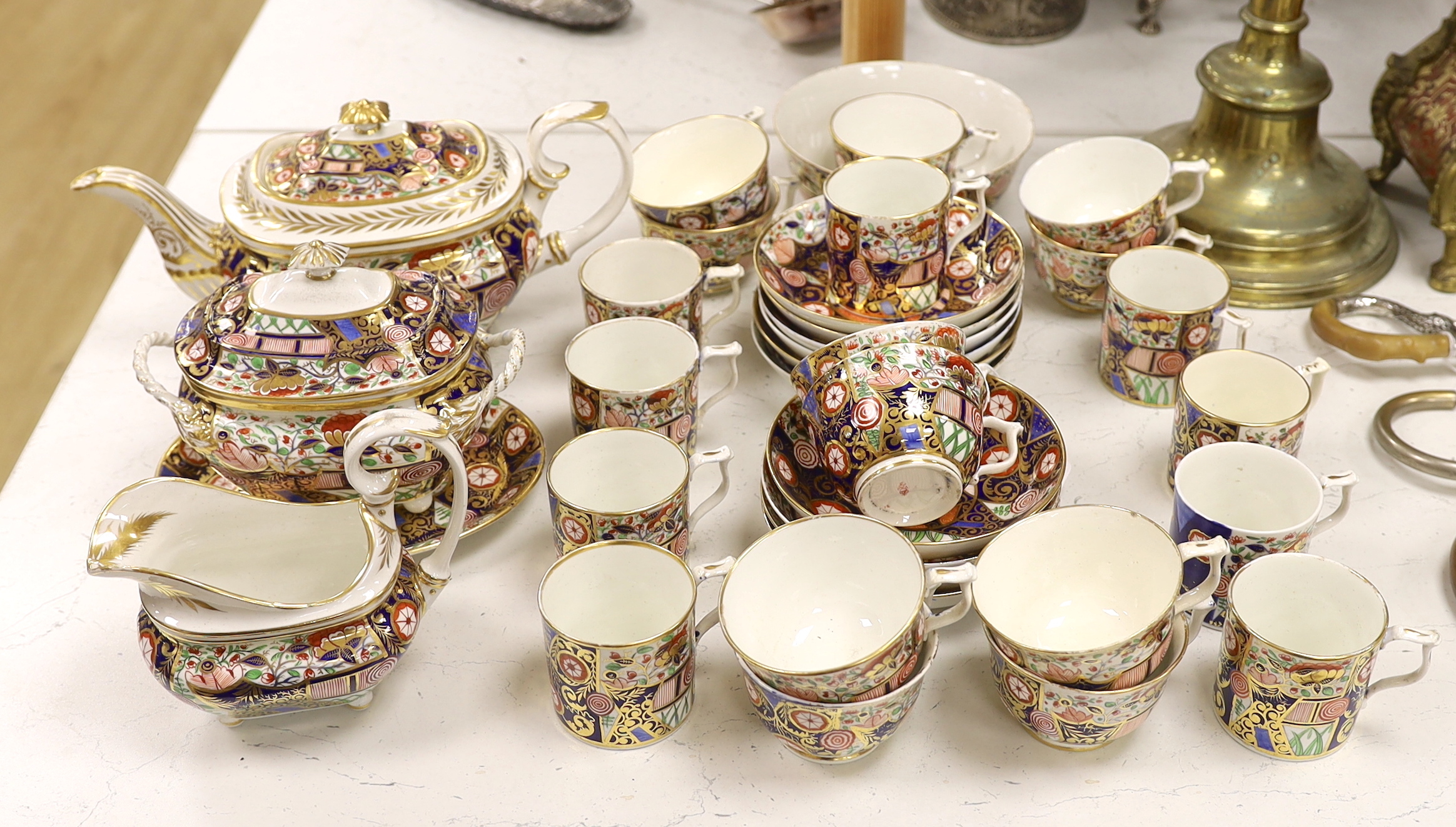 An early 19th century Derby Japan pattern part tea and coffee set, including cups and saucers, teapot, milk jug and bowl
